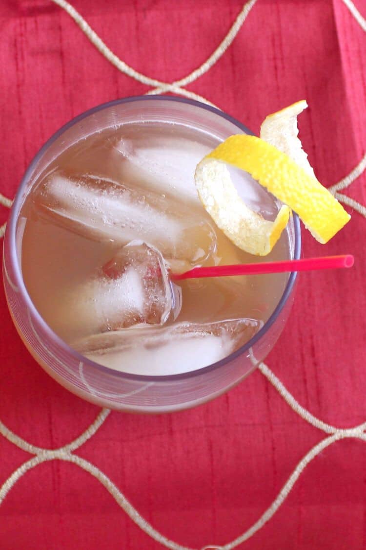 Amaretto Sour cocktail Overhead view of Amaretto Sour cocktail with lemon twist