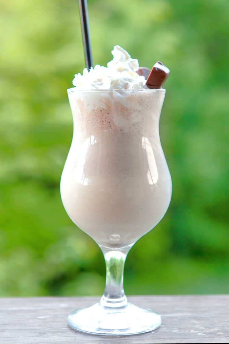 Pensacola Bushwacker drink in parfait glass with chocolate candy garnish