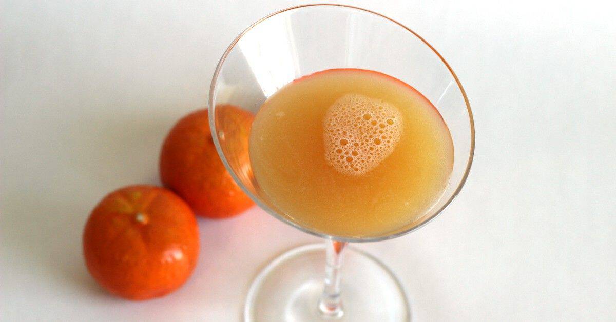 Satan's Whiskers drink surrounded by oranges